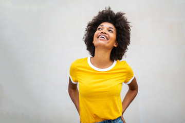 Wall Mural - cheerful young black woman looking up