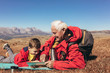 © Mediteraneo - Boy camping with grandfather in autumn.