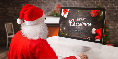 Merry Christmas and Happy New Year greeting card on computer display. Santa send greeting card online concept.