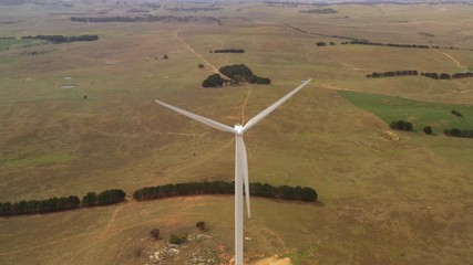 Wall Mural - aerial view of a large wind turbine moving to create kinetic energy for renewable energy supply loca