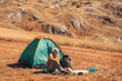 © Mediteraneo - Senior man sitting by tent and rest in the countryside.