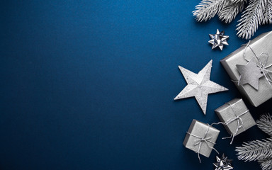 merry christmas ornaments and gift on blue background top view. xmas and new year holiday theme. fla