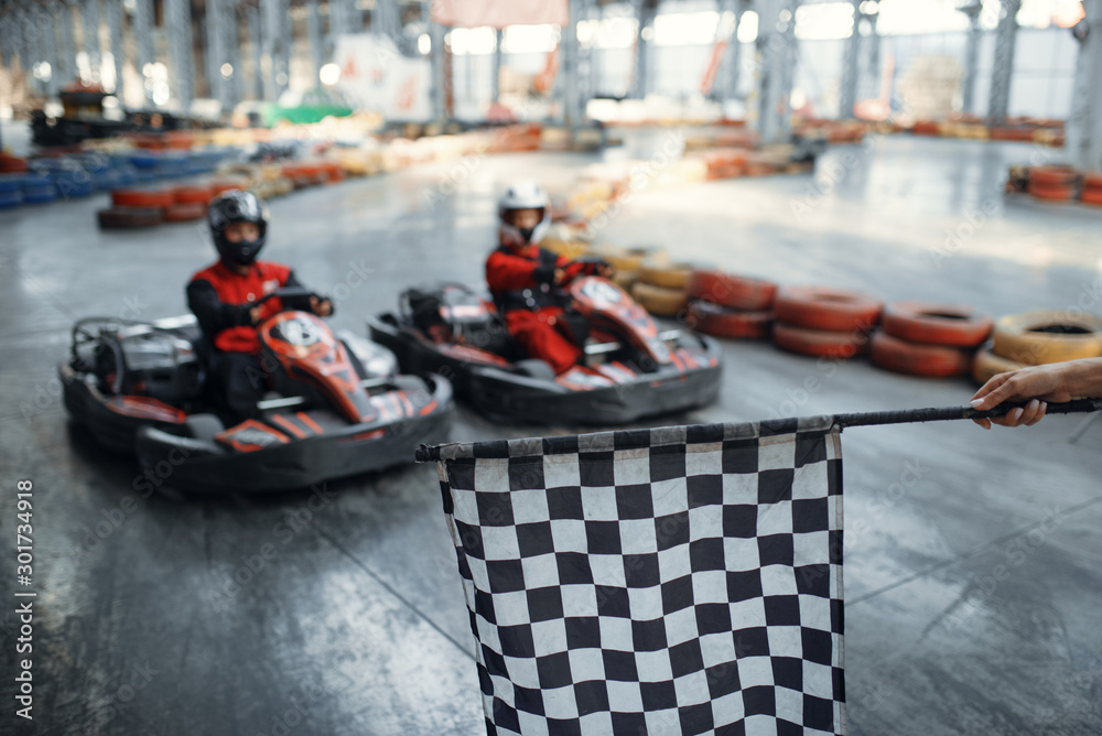 Two kart racers on start line, checkered flag - obrazy, fototapety, plakaty 