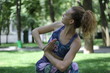 © Alexandr - Girl with curly blond hair doing yoga outdoors in the park.