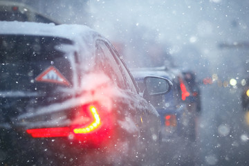 cars on winter road traffic jam city / winter weather on the city highway, the view from car in the fog and snow road