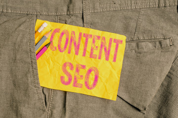 Fototapete - Word writing text Content Seo. Business photo showcasing creating webpage content to rank high in the search engines Writing equipment and yellow note paper inside pocket of man work trousers