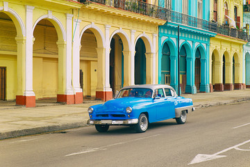 Wall Mural - old american car driving through the central streets of havana, cuba