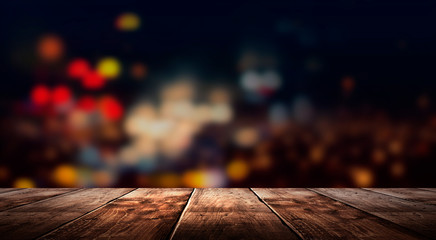 Wall Mural - Wooden table, blurred bokeh background background. Neon light, night view, close-up. The general background of the interior, a dark background.