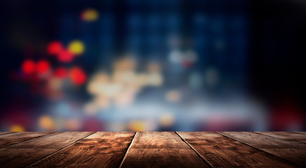 Wall Mural - Wooden table, blurred bokeh background background. Neon light, night view, close-up. The general background of the interior, a dark background.