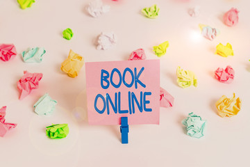Writing note showing Book Online. Business concept for booklike form that is only available to read on the Internet Colored crumpled paper empty reminder white floor clothespin