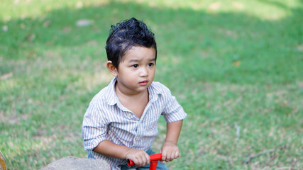 Asian Children 2 year old playing in the garden outdoor holiday kid concept.