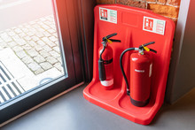Two Red Tank Of Fire Extinguisher Water And CO2 (Carbon Dioxide) Service On The Floor In Office, School Or Shopping Mall. Indoor Red Fire Extinguisher For Safety.