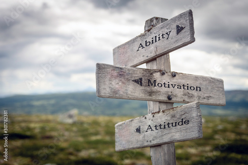 Fotografía Ability, motivation and attitude text on wooden sign post outdoors in landscape scenery