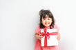 © MIA Studio - Little asian girl smile and excited and holding red gift box on white background.child holding gift box in Christmas and New year concept.