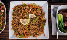 A Filipino Noodle Cuisine Called Pansit Served Together With The Other Dishes