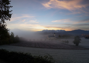 Wall Mural - beautiful foggy autumn morning in bavaria - aerial view of wilparting church before alps in chiemgau