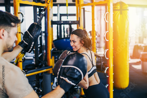 Принти на полотні Young attractive woman with instructor on kickboxing training