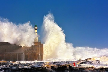  Stormy wave over lighthouse of San Esteban de Pravia.