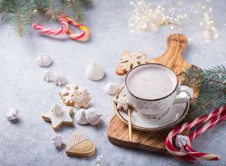 Hot chocolate cacao drinks with gingerbread  in Christmas white mug on grey background. Traditional holiday hot beverage, festive cocktail at X-mas or New Year. top view