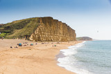 Dramatic layered cliffs of Bridport sandstone along the west Dorset Jurassic coast with Chesil beach disappearing in to the background