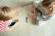 © spass - Two clever children study mathematics playing with colorful dices