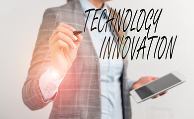 Poster - Handwriting text writing Technology Innovation. Conceptual photo significant technological changes of products Business woman pointing in empty space with pen and mobile phone