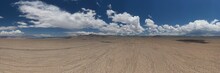 Panoramic Shot Of The Desert Under The Clouds In The Blue Sky Captured In California