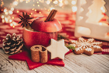 Christmas Baked Apple For Christmas In Christmas Decoration With Cinnamon Stick And Orange And Advent Candle