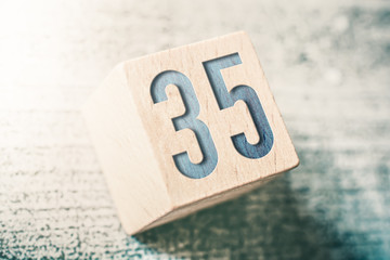 Poster - Number 35 On A Wooden Block On A Table