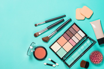 Makeup professional cosmetics on mint background.