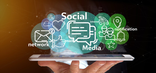 businessman holding a cloud of social media network icon