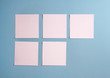 5 blank empty white sticky notes on clean blue background with free space, from top view with copy space