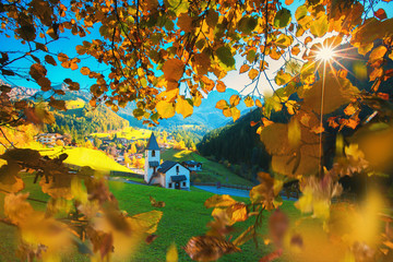 Wall Mural - mountain autumn landscape and a church in the field of the dolomites.
