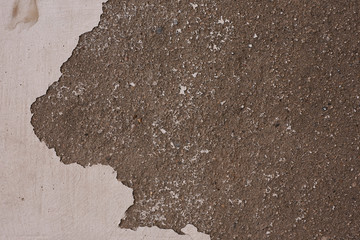 Fragment of old grungy texture with chipped paint and cracks or grey concrete wall and cement surface