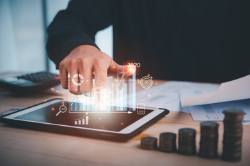 Poster - businessman touch on digital tablet.business analytics and financial technology concept, virtual screen chart from the screen of digital tablet computer. indicators of positive growth in 2020.