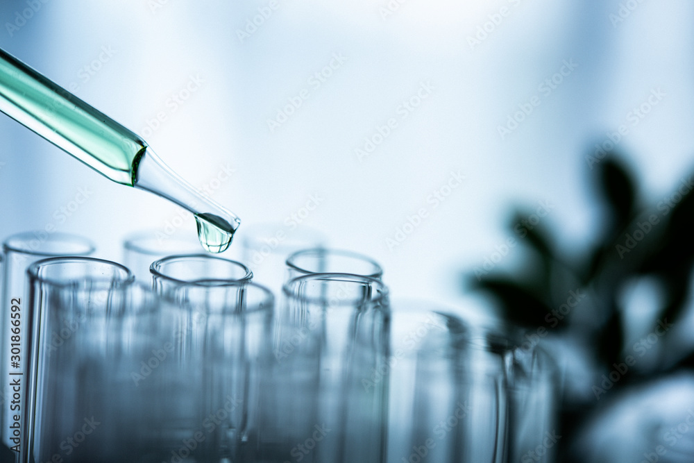 Dropper over test tube dropping sample chemical into sample herbal ...