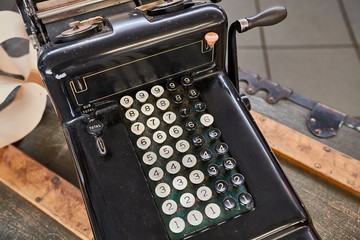 Vintage calculator and cash register on a counter