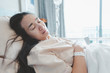 © Looker_Studio - Asian woman lying on the hospital bed for admitting.Hospitalization concept.