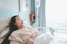 Asian Woman Lying On The Hospital Bed For Admitting.Hospitalization Concept.