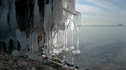 Wall Mural - ice icicles from cold waves on a lake at the beginning of winter.