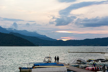 Couple Watching The Sunset On The Lake Of Valle De Bravo