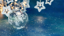 Festive New Year Background With Christmas Tree Glass Ball And Glowing Star Garlands Blurred Background