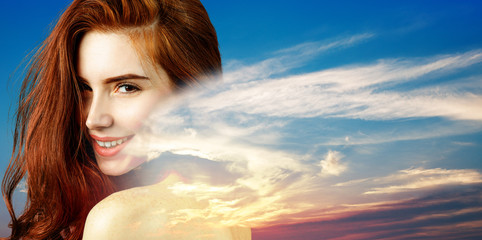 Double exposure of beautiful redhead woman face and sunset.