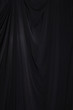 Black Curtain drape wave with studio lighting, Wallpaper Background Texture Detail of light and shadow, stage opening screen for performance and music