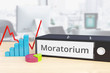 Moratorium – Finance/Economy. Folder on desk with label beside diagrams. Business/statistics. 3d rendering