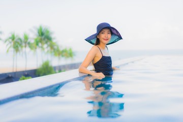 Portrait beautiful young asian women happy smile relax outdoor swimming pool in hotel