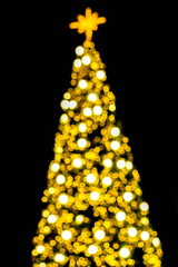 Wall Mural - Blurred and bokeh of Christmas lighting on Christmas tree and black background.