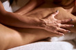 Close up of strong female physiotherapist doing back oil massage in luxury spa resort, keeping palm on back, press hardly, well being wellness center