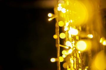 Wall Mural - Closeup blurred and bokeh of Christmas lights and refection lighting on black background.