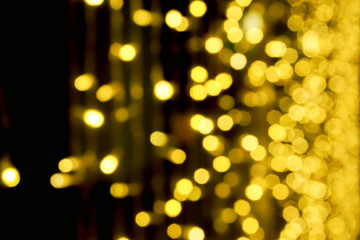 Wall Mural - Blurred and bokeh of Christmas lights on black background.